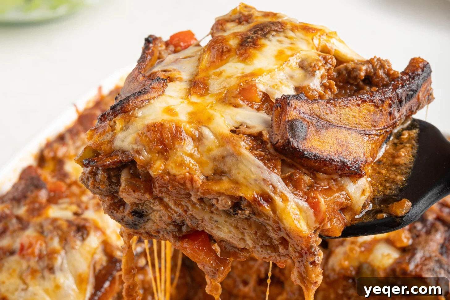 Caramelized Plantain Lasagna 9 a slice of pastelón being lifted by a spatula