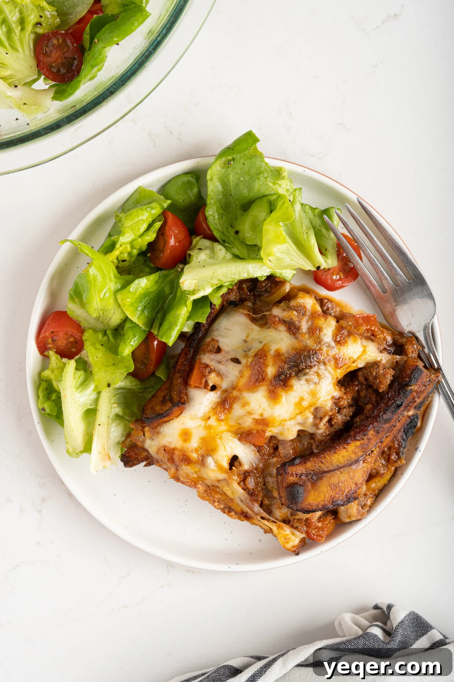 Caramelized Plantain Lasagna 10 a plate of pastelón and ensalada verde