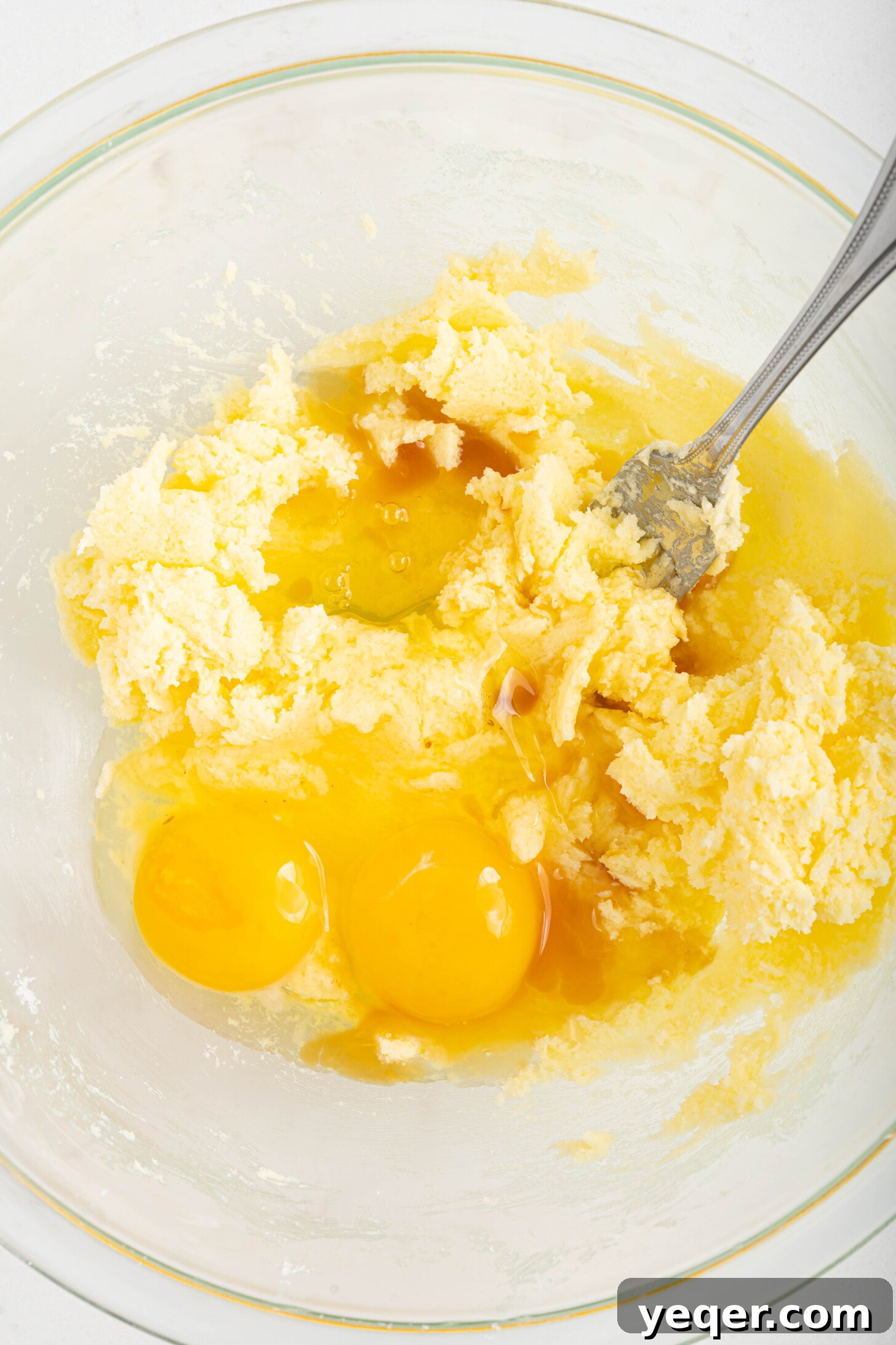 Easy Dulce de Leche Thumbprint Cookies 5 Creamed butter and sugar mixture with eggs and vanilla extract added, ready for mixing.
