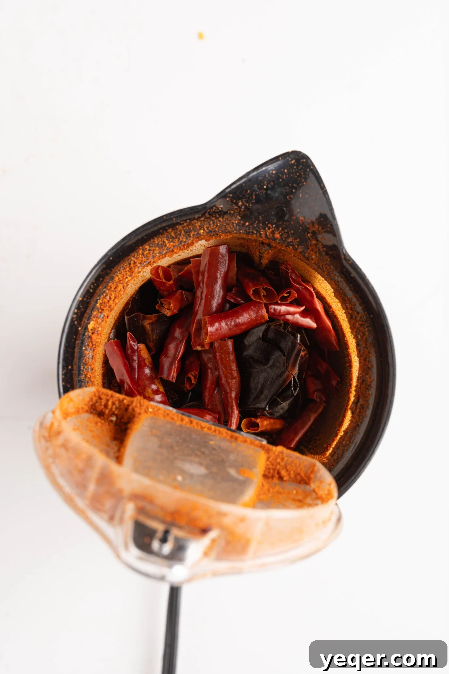 Whip Up Paprika in Minutes 4 Dried red peppers being prepared for grinding, with stems and seeds removed.