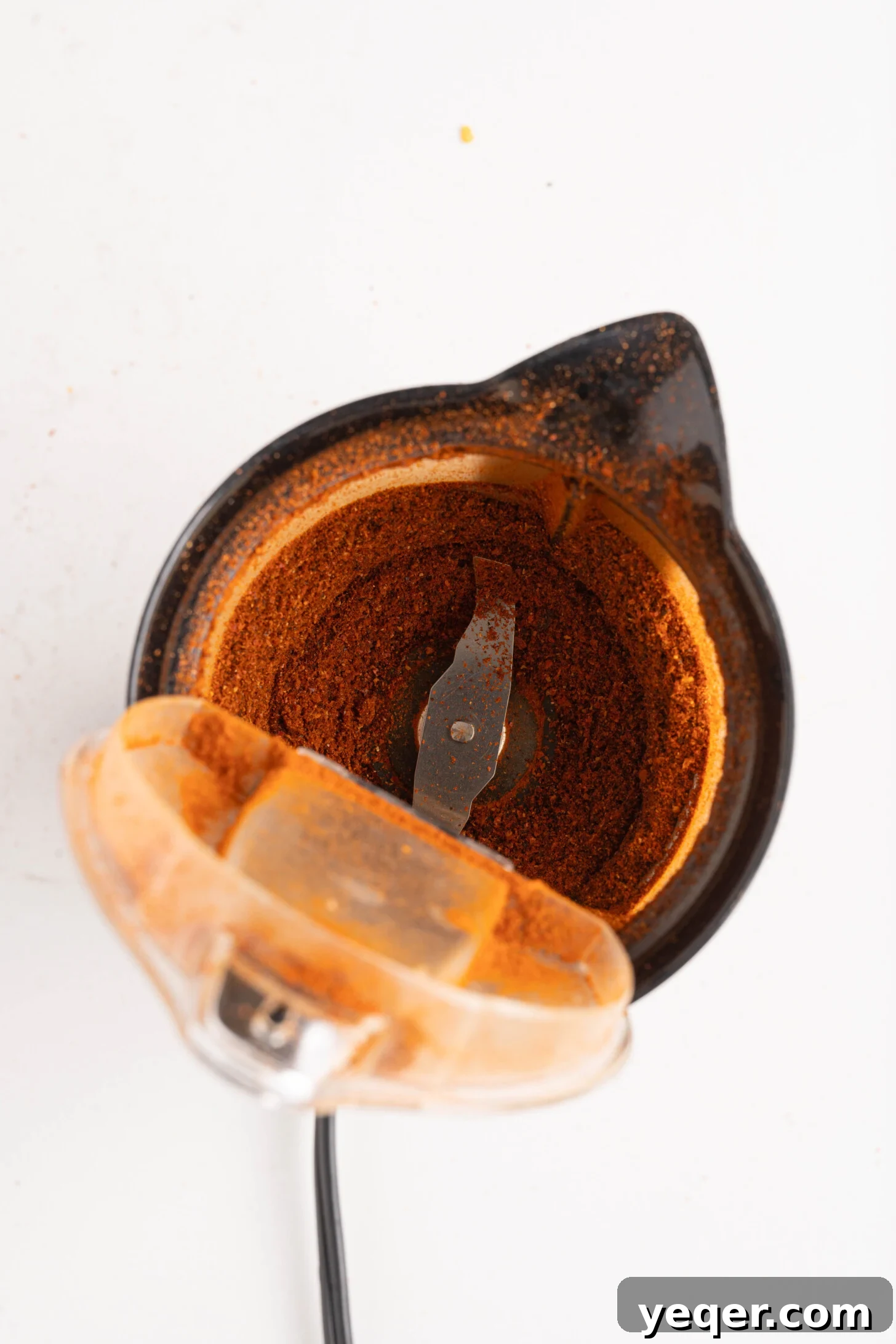 Whip Up Paprika in Minutes 5 Finely ground homemade paprika in a spice blender, showcasing its rich color and texture.