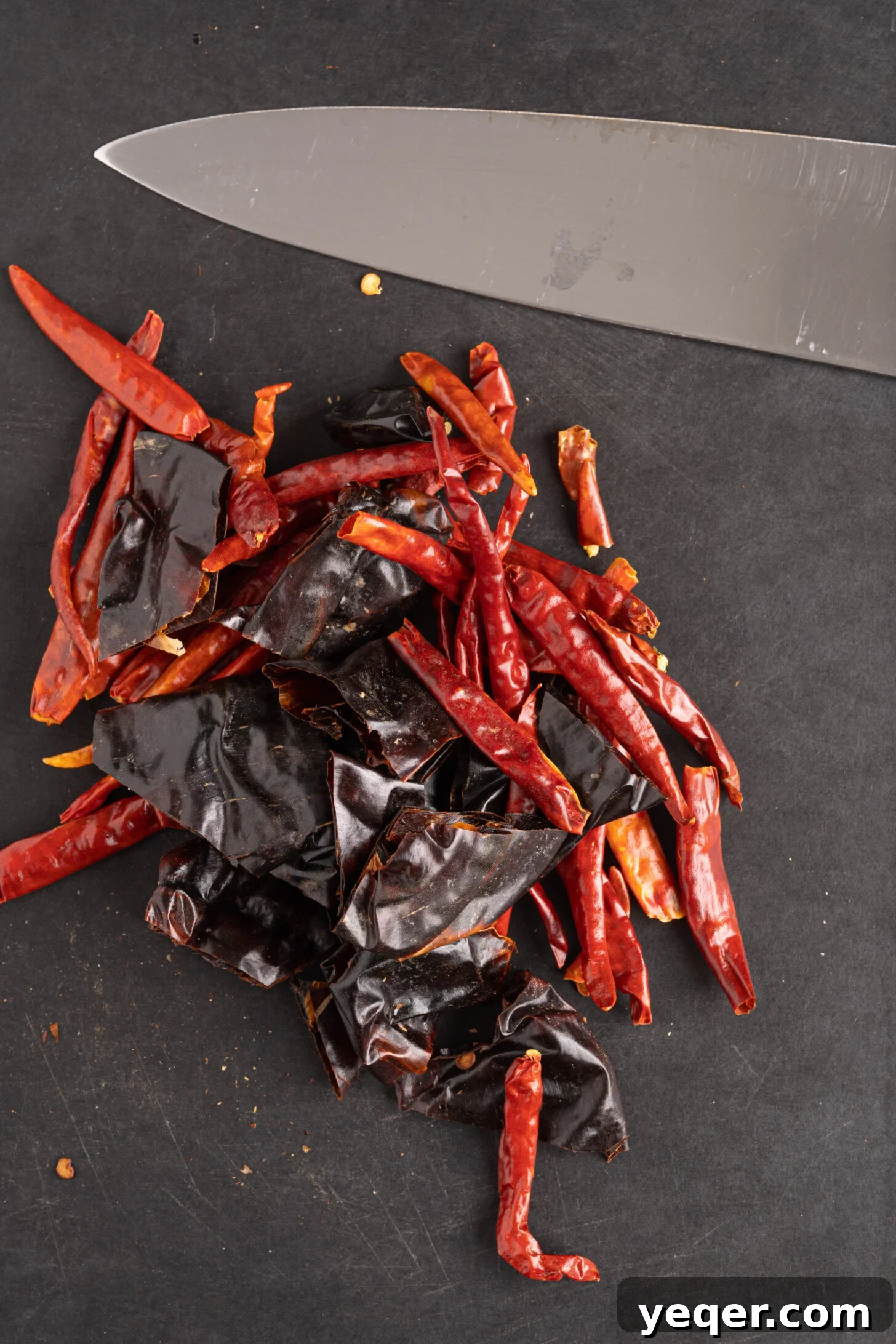 Whip Up Paprika in Minutes 6 Chopped dried red peppers on a cutting board, ready for the spice grinder.