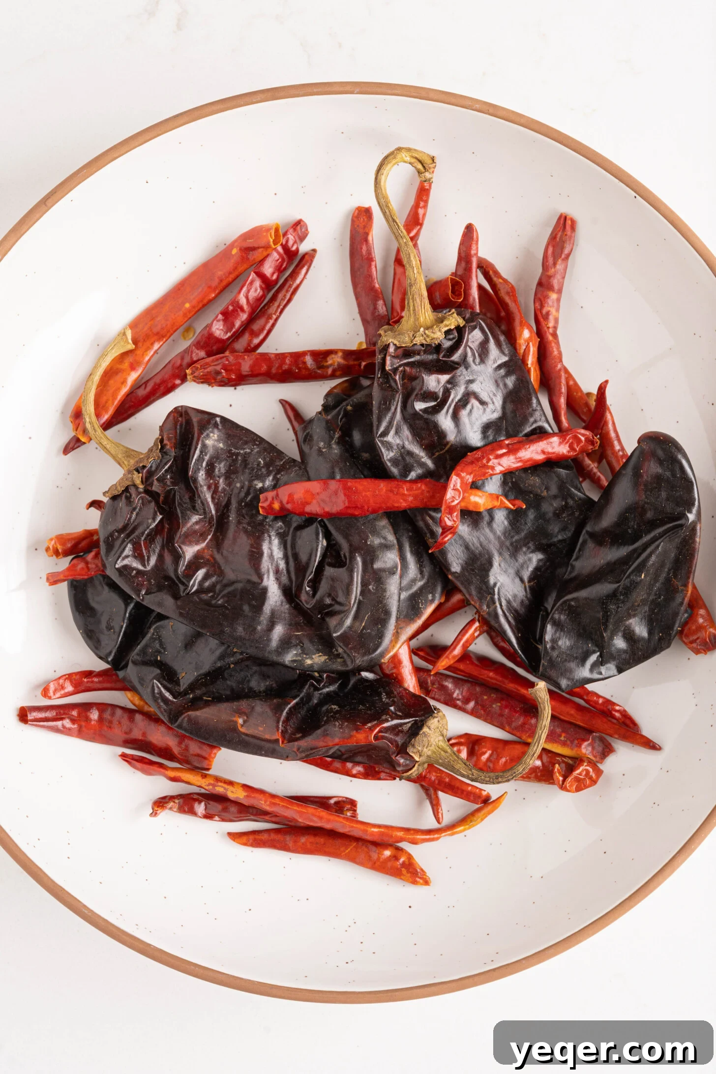 Whip Up Paprika in Minutes 3 A bowl filled with various dried red peppers, ready for grinding into homemade paprika.