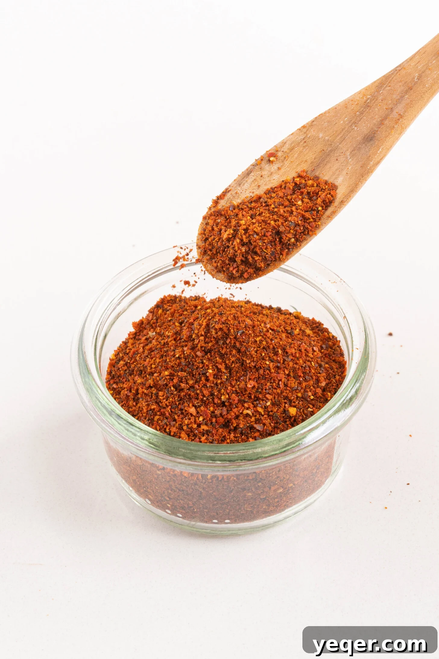 Whip Up Paprika in Minutes 7 A small jar of homemade paprika with a wooden spoon, symbolizing freshness and culinary delight.