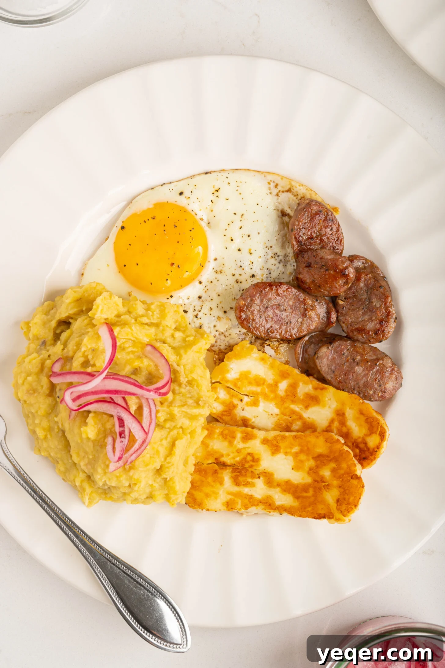 Whip Up Dominican Mangu in 30 Minutes 9 A complete plate of Los Tres Golpes with Mangu, fried egg, fried white cheese, and Dominican sausage.