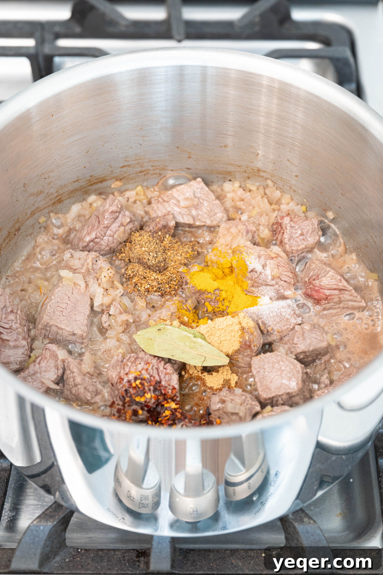 Moroccan Lamb Orzo Pilaf 5 The same pot, now with the sautéed lamb, onions, and all the Moroccan spices and fresh herbs added, being mixed together.