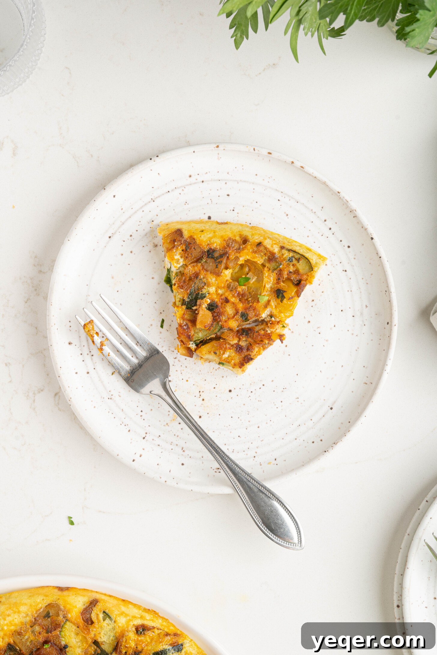Moroccan Golden Potato Frittata 12 a perfectly sliced piece of potato omelette, revealing layers of eggs, potatoes, and vegetables