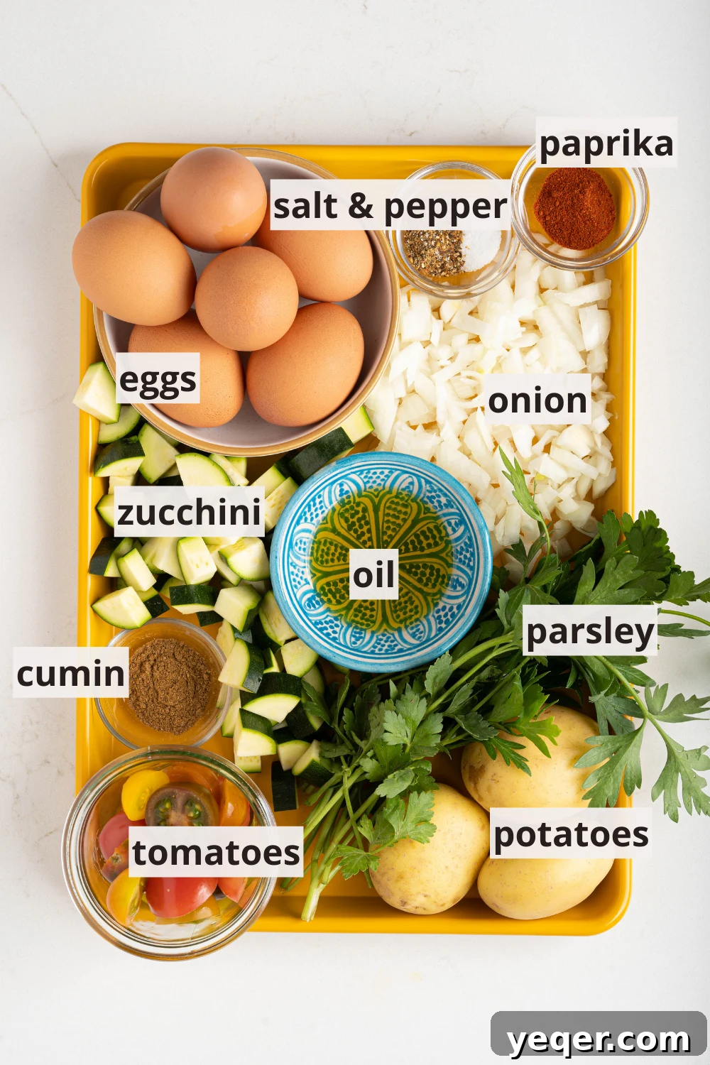 Moroccan Golden Potato Frittata 3 bowls of fresh ingredients including eggs, olive oil, diced tomatoes, and zucchini, ready for cooking