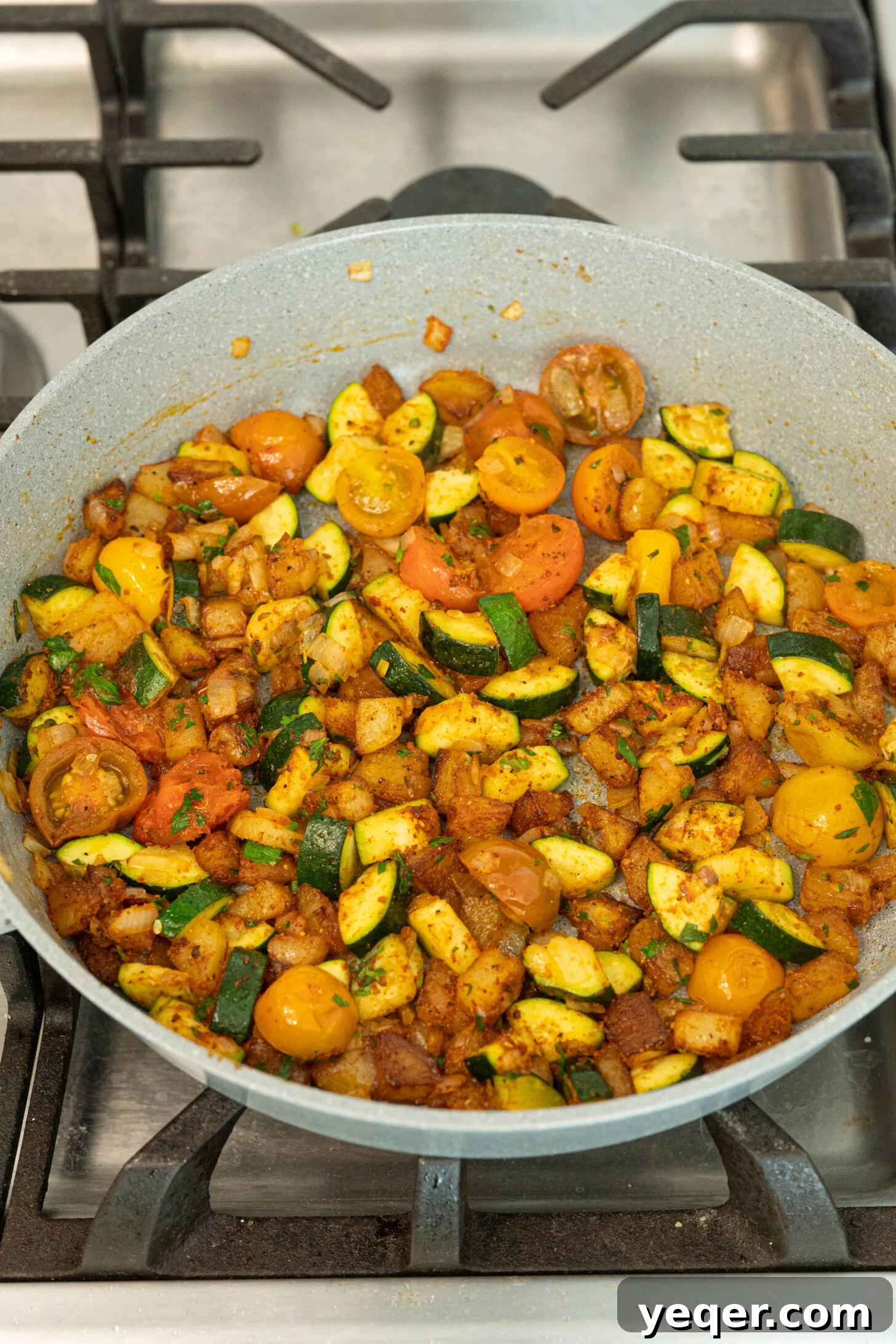 Moroccan Golden Potato Frittata 8 cooked vegetables in a pan, coated with spices and herbs, ready for the eggs