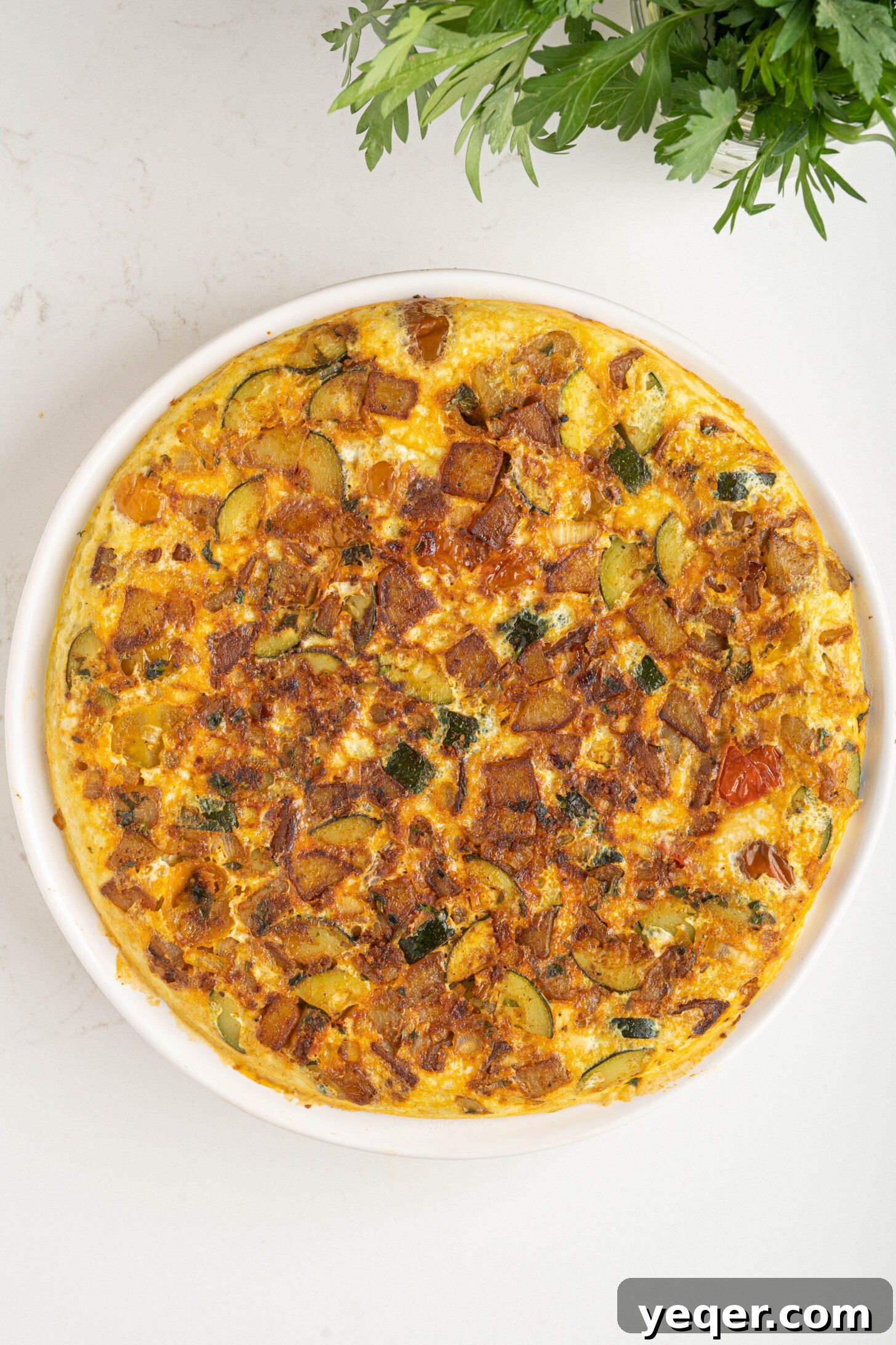 Moroccan Golden Potato Frittata 10 a fully cooked potato omelette, inverted onto a serving plate, showing its golden-brown exterior