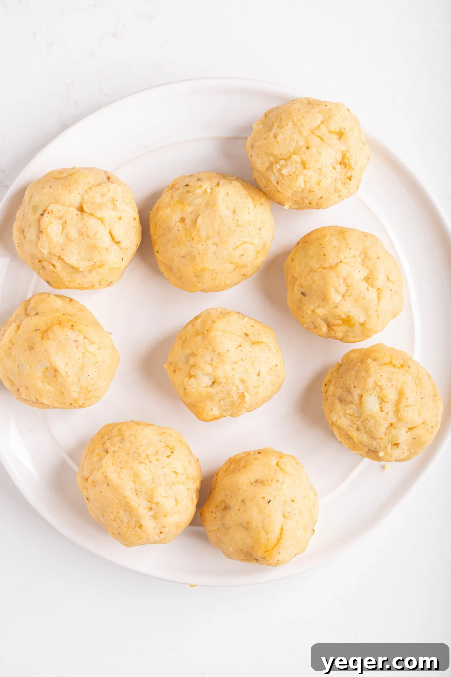 Golden Crispy Stuffed Potatoes 13 Several uncooked Papas Rellenas, perfectly shaped and ready for frying, lined up on a tray.