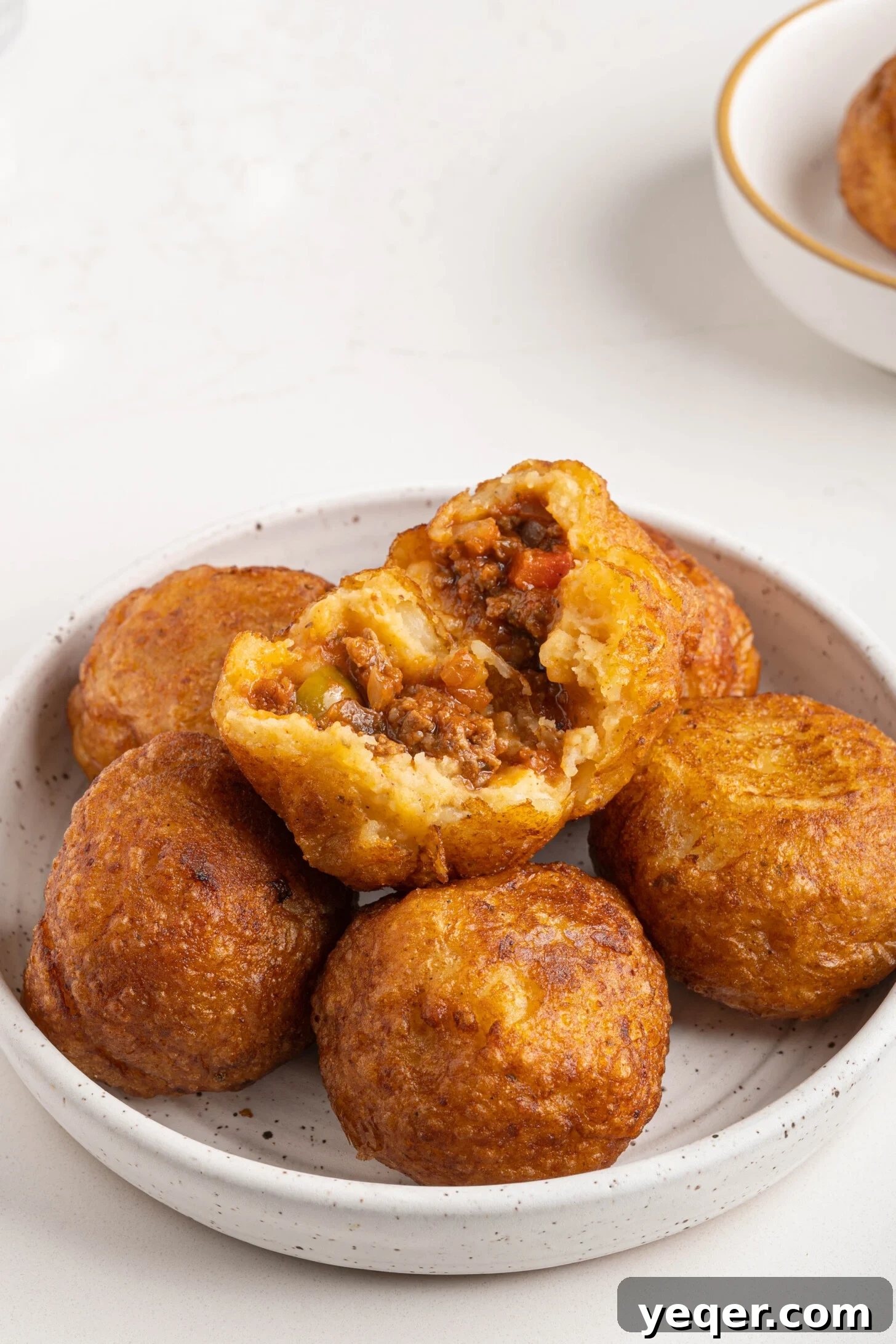 Golden Crispy Stuffed Potatoes 14 A generous serving of Papas Rellenas, beautifully golden and garnished, ready to be enjoyed as a meal or snack.