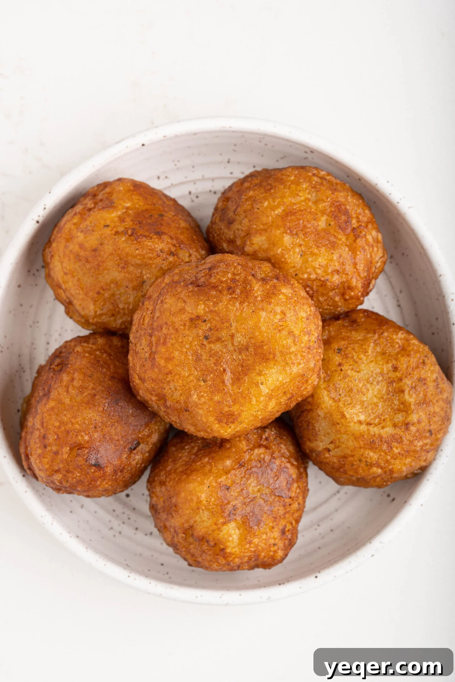 Golden Crispy Stuffed Potatoes 4 A close-up shot of several golden-brown Papas Rellenas arranged artfully on a plate, highlighting their crispy texture.