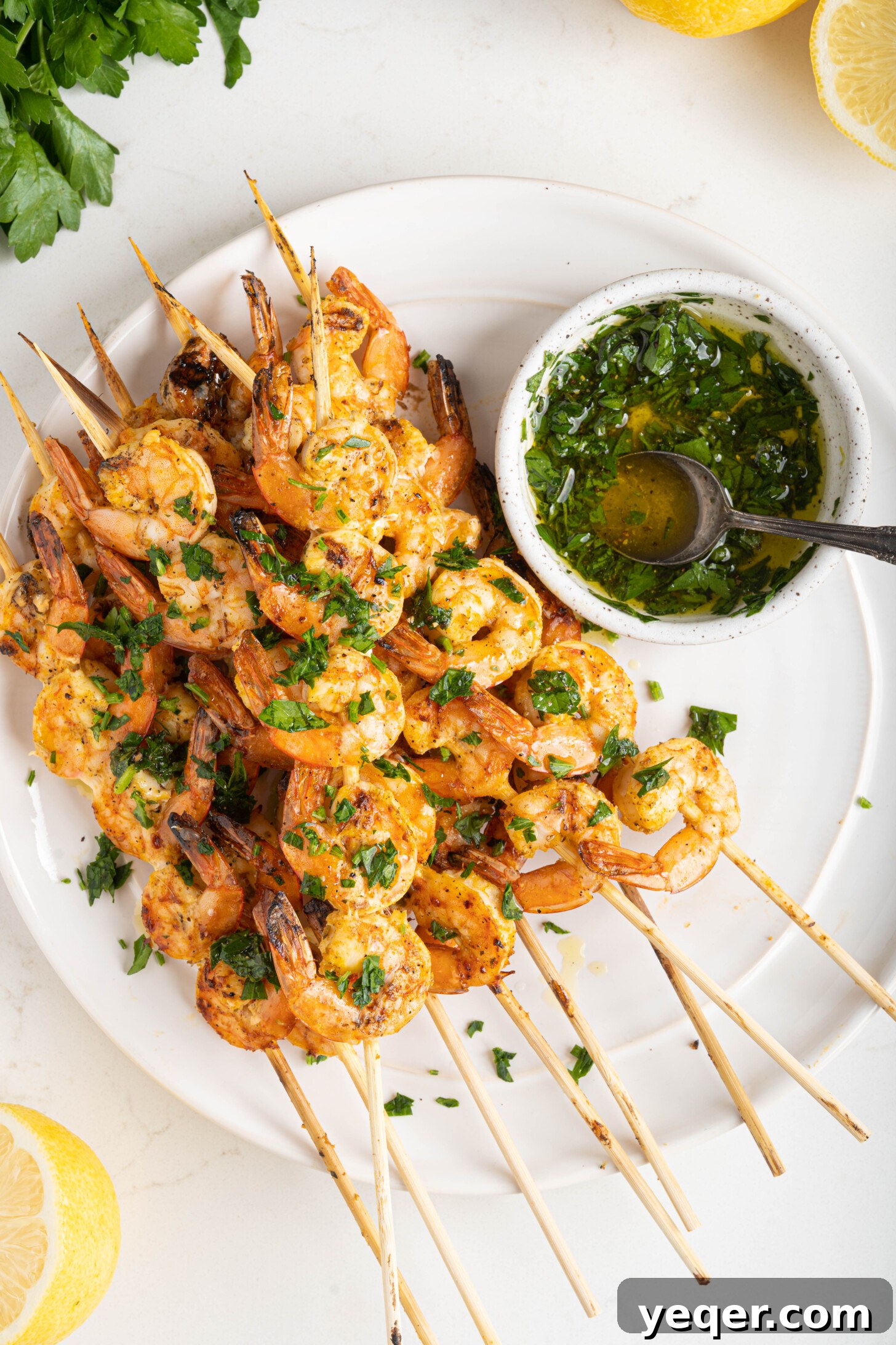 Simply Delicious 5 Ingredient Grilled Shrimp Skewers 9 Close-up of three grilled shrimp skewers on a white plate, beautifully cooked and ready to be served.