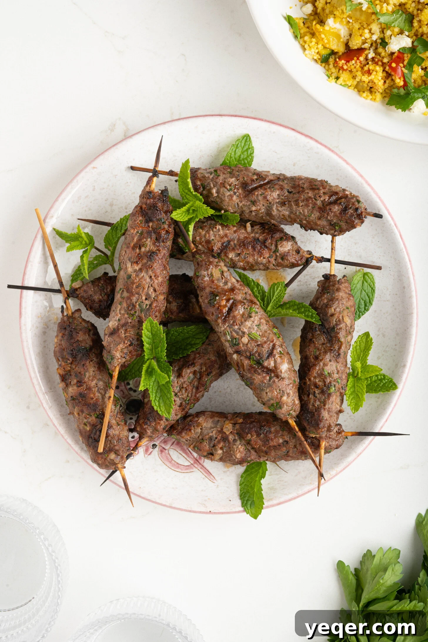 Sizzling Moroccan Kefta in 30 Minutes 2 A beautifully arranged plate of freshly grilled Moroccan kefta skewers, garnished with herbs.