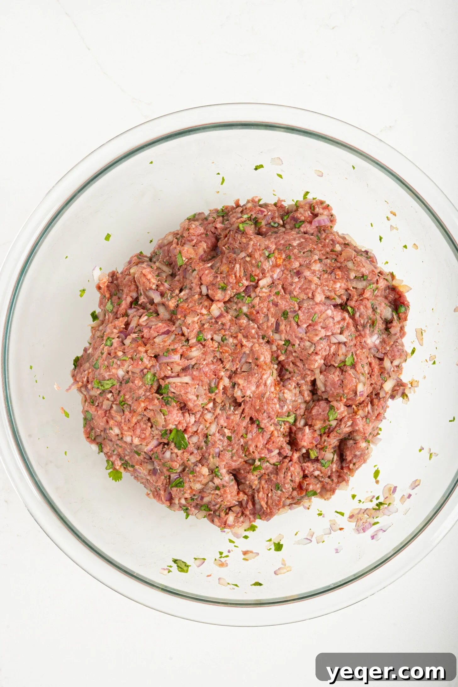 Sizzling Moroccan Kefta in 30 Minutes 5 A bowl of seasoned raw kefta meat, covered and ready for refrigeration.