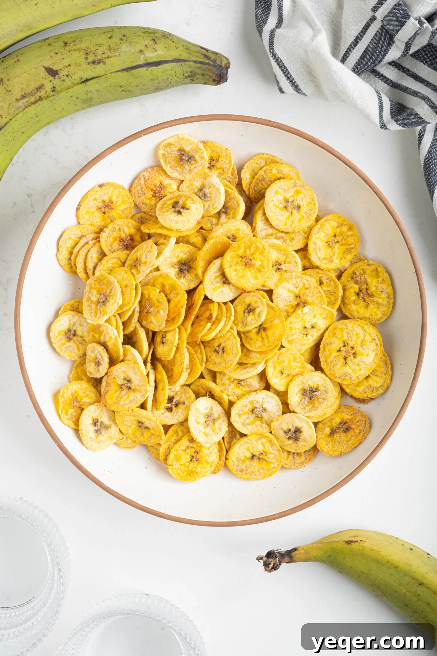 Effortless Oven-Baked Plantain Crisps 2 A vibrant bowl of golden baked plantain chips, perfectly crispy and ready to be enjoyed as a healthy snack or appetizer.