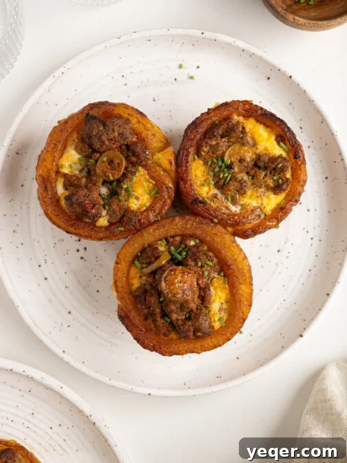 Puerto Rican Stuffed Plantain Cups 14 A plate of golden-brown Puerto Rican Piononos, showcasing the sweet plantain cups filled with savory picadillo and baked egg topping.