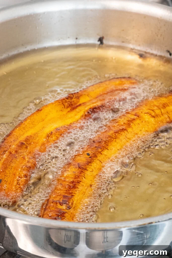 Puerto Rican Stuffed Plantain Cups 6 Plantain strips frying in hot oil until golden brown.