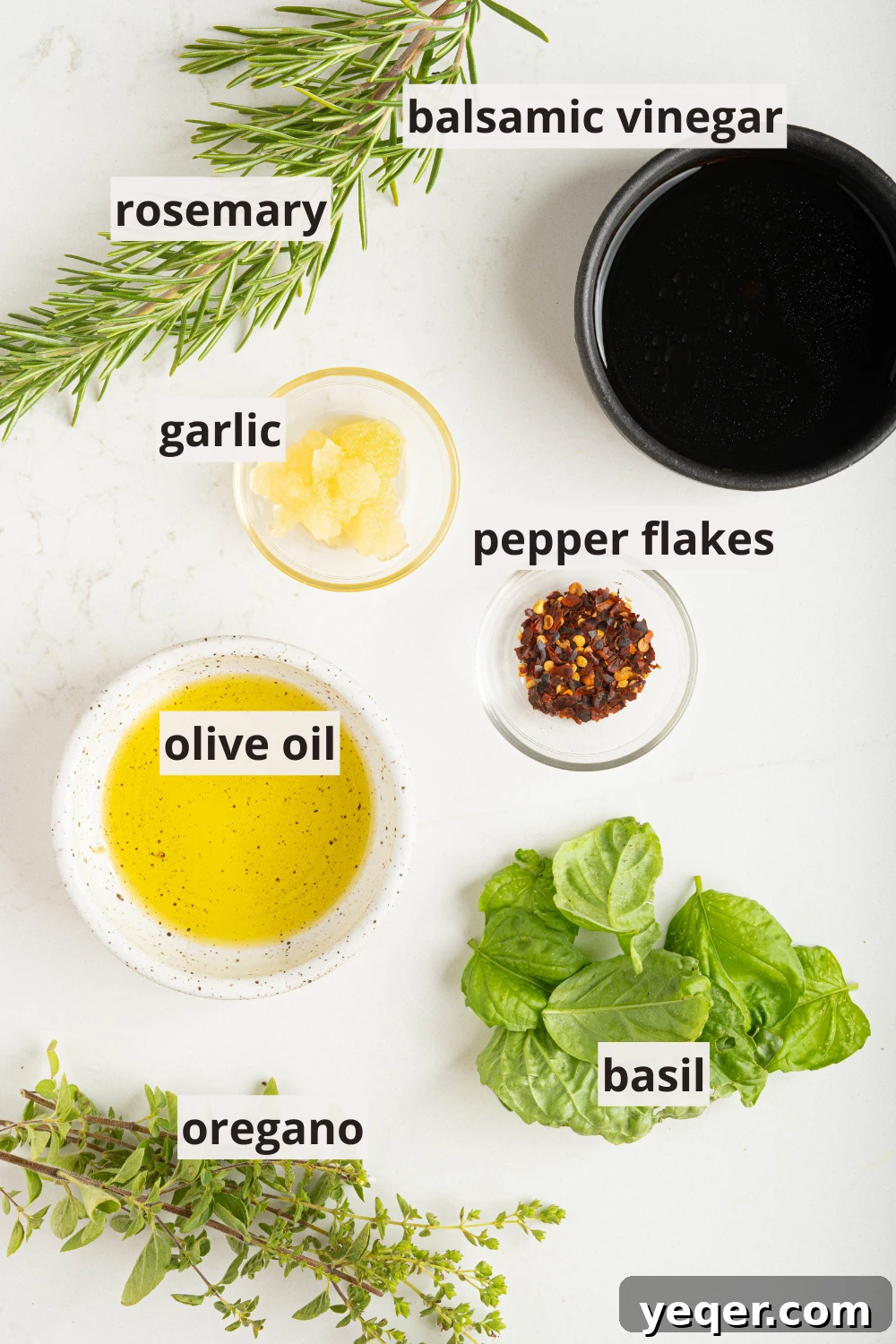 Effortless Grilled Vegetables: 3-Ingredient Marinade 4 Small bowls containing minced garlic, fresh herbs like oregano, rosemary, and basil, along with olive oil, balsamic vinegar, and red pepper flakes, all ready for making the dressing.