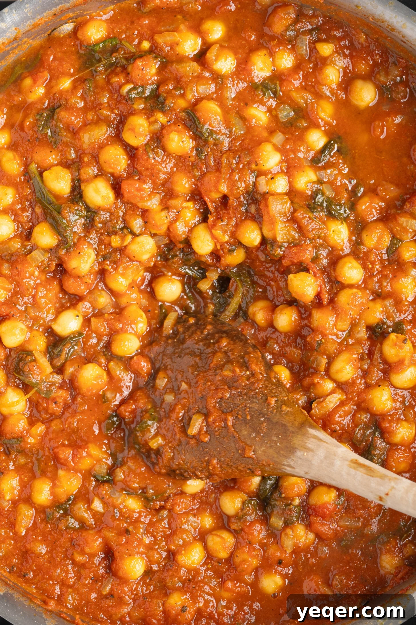 Hearty 30-Minute Moroccan Chickpea and Tomato Stew 9 A large pot filled with rich, stewed chickpeas and tomatoes, ready to be served.