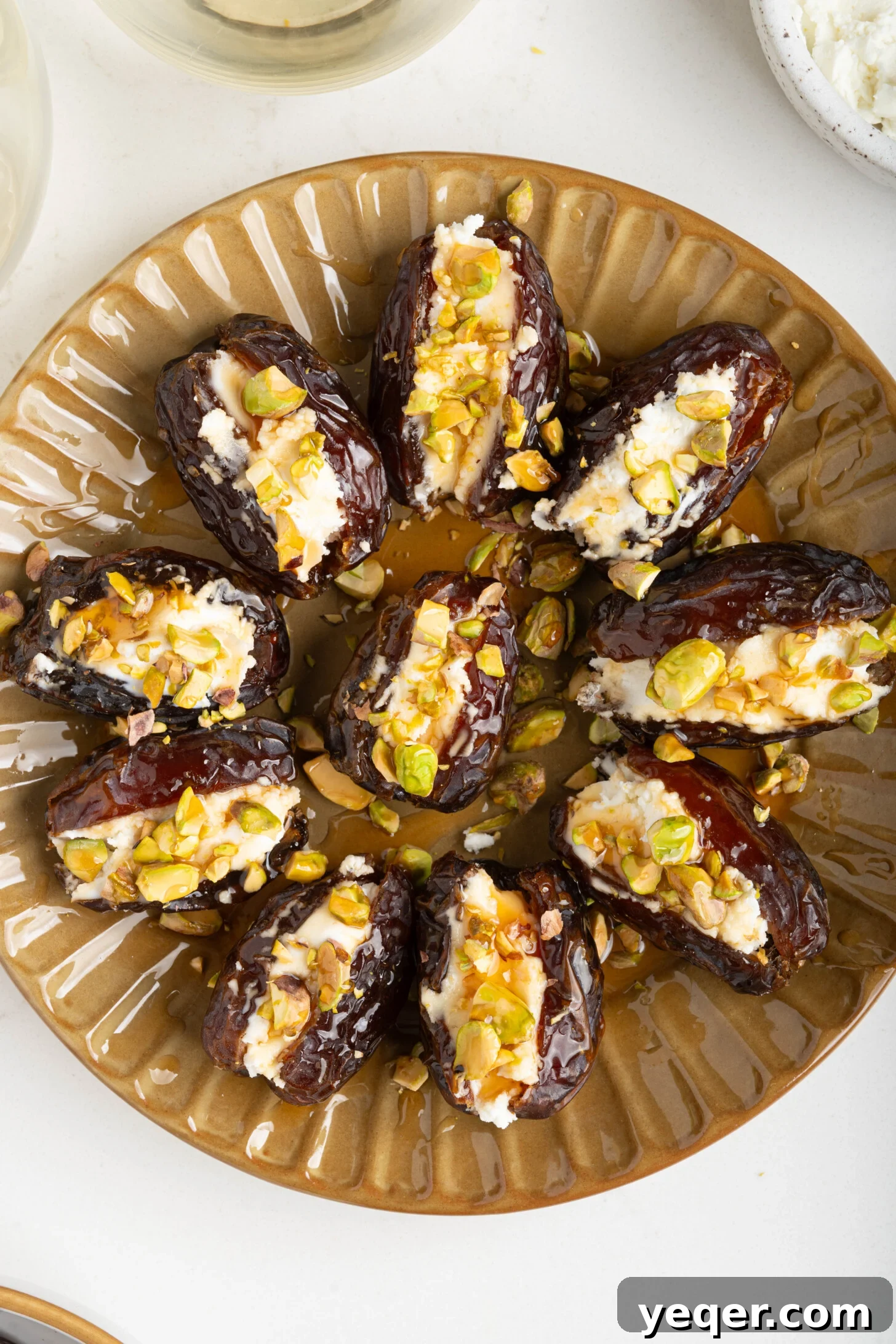 Gourmet Date Medallions: Goat Cheese and Pistachio Bliss 9 A close-up shot of several goat cheese stuffed dates, artfully arranged on a serving plate, ready to be enjoyed.