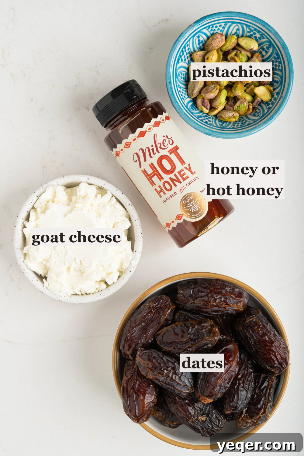 Gourmet Date Medallions: Goat Cheese and Pistachio Bliss 3 Various bowls holding the core ingredients for the stuffed dates: goat cheese, chopped pistachios, whole Medjool dates, and a small jar of honey.