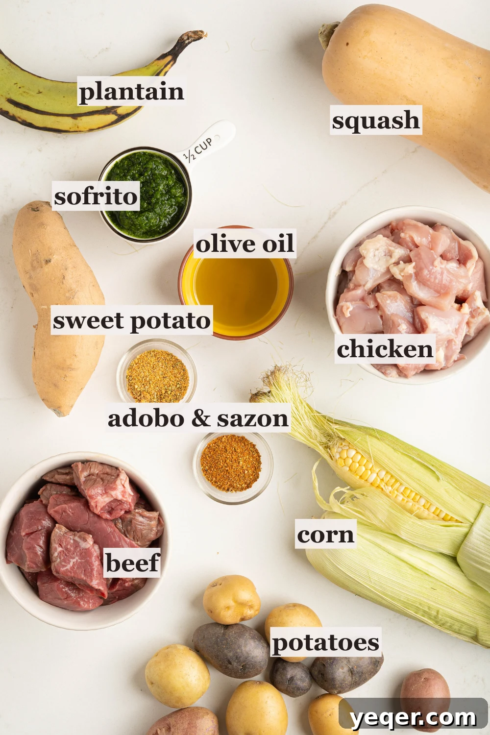 Rich Puerto Rican Sancocho Beef and Root Vegetable Stew 3 Bowls filled with sofrito, various island spices, olive oil, raw beef and chicken, and an assortment of fresh root vegetables and corn, all laid out on a kitchen counter.