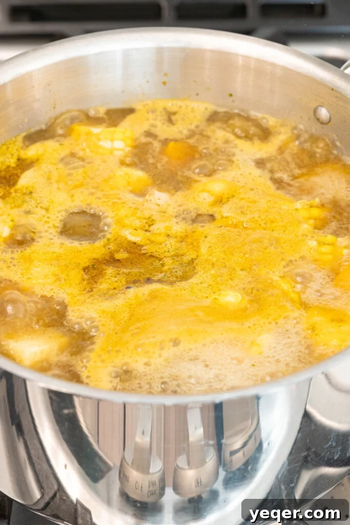 Rich Puerto Rican Sancocho Beef and Root Vegetable Stew 7 A pot of Sancocho stew simmering gently on the stovetop, covered to allow the flavors to meld and the ingredients to tenderize.