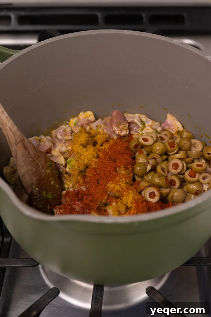 Puerto Rican Pasteles: Savory Meat-Stuffed Masa Delights 7 Diced chicken with spices and olives simmering in a pot, creating a rich filling.