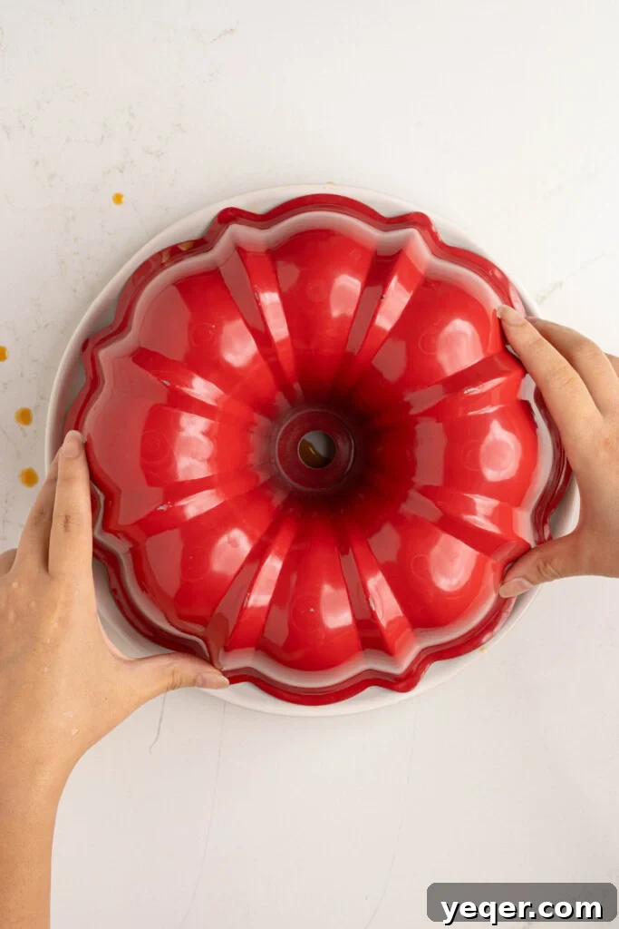 Puerto Rican Flancocho: Vanilla Cake and Creamy Flan Fusion 13 The Flancocho being carefully inverted onto a serving platter after cooling.