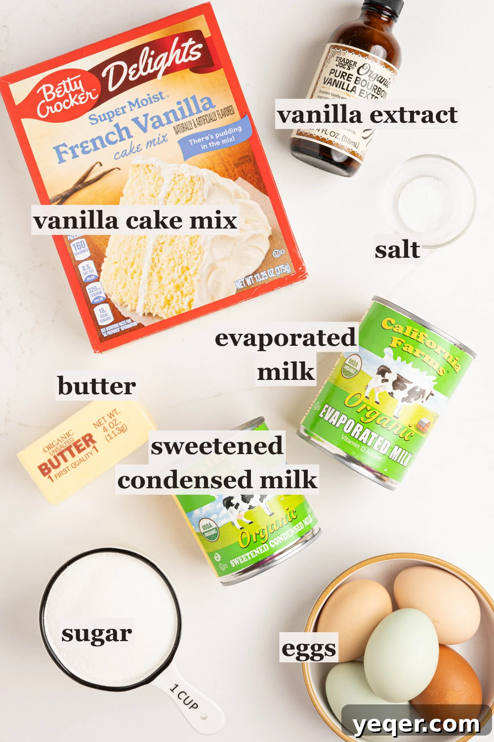 Puerto Rican Flancocho: Vanilla Cake and Creamy Flan Fusion 4 Various baking ingredients in bowls including sugar, eggs, and salt, ready for making Flancocho.