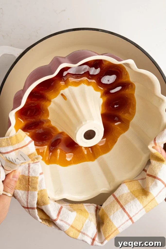 Puerto Rican Flancocho: Vanilla Cake and Creamy Flan Fusion 6 Liquid caramel being carefully poured into a bundt pan, ensuring an even layer at the bottom.