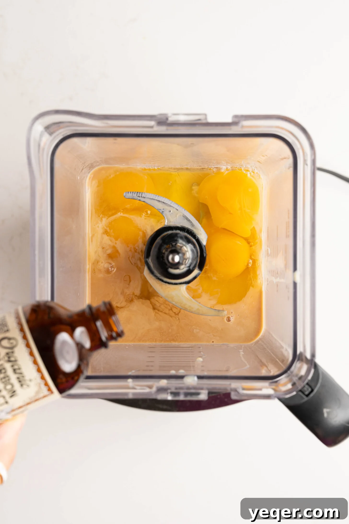 Puerto Rican Flancocho: Vanilla Cake and Creamy Flan Fusion 8 Ingredients for flan—eggs, milk, and vanilla extract—being blended together in a blender until smooth.