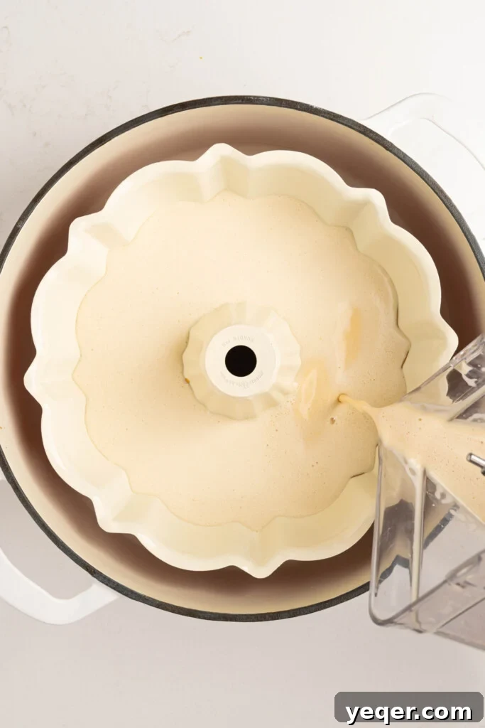 Puerto Rican Flancocho: Vanilla Cake and Creamy Flan Fusion 9 Smooth flan batter being carefully poured over the hardened caramel layer in the bundt pan.