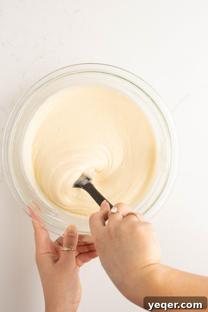 Puerto Rican Flancocho: Vanilla Cake and Creamy Flan Fusion 10 Vanilla cake batter being gently mixed in a bowl according to package directions.