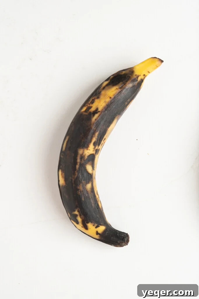Master the Art of Peeling Any Plantain 3 A brown plantain resting on a clean kitchen counter, ready for preparation.