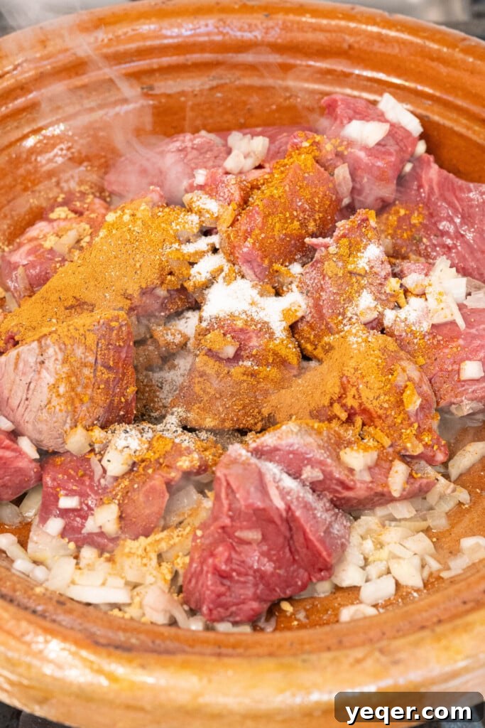 Rich Moroccan Beef Tagine with Tomatoes and Onions 5 seasonings with beef and onions in a tagine