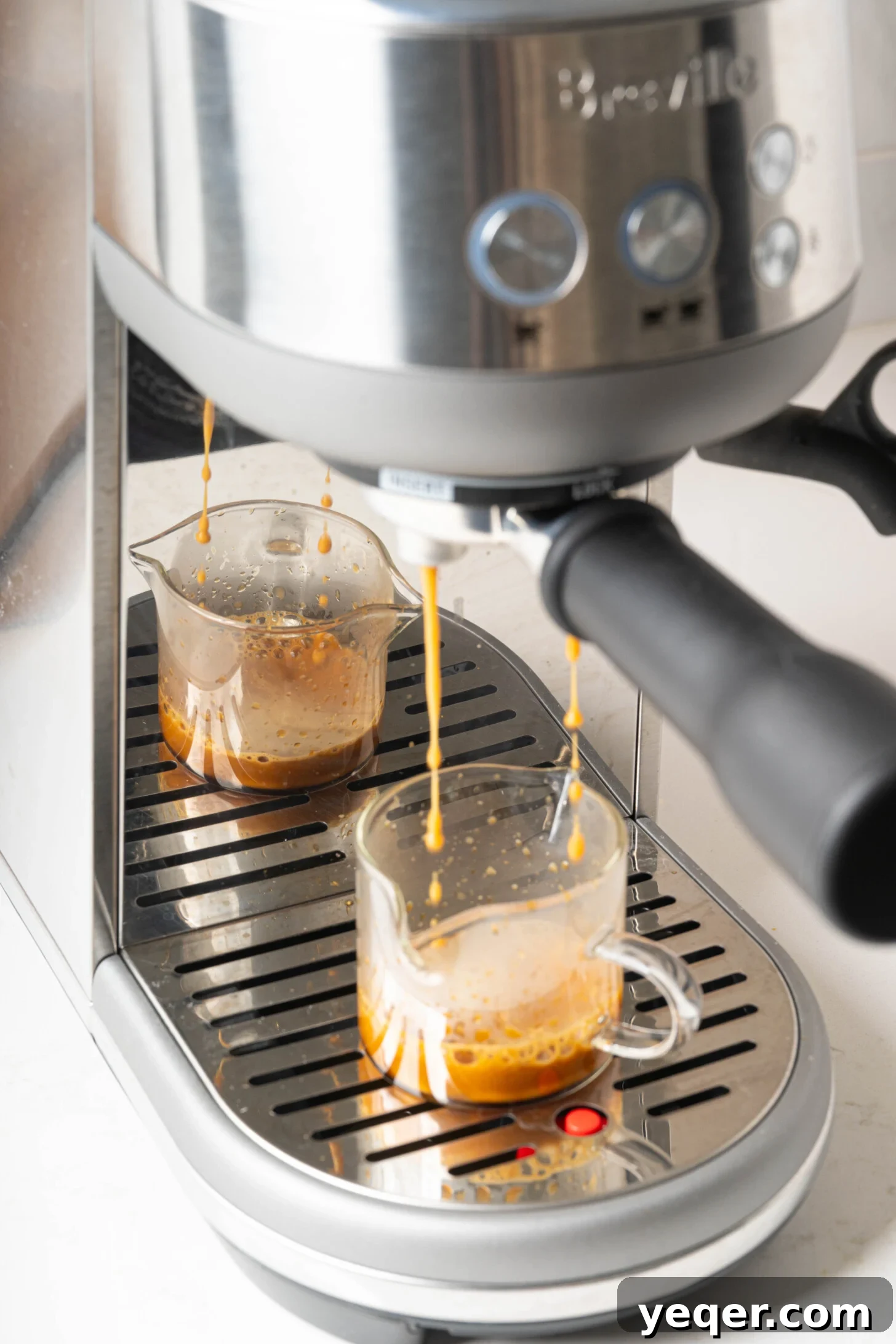 Your 10-Minute Cortado Perfect 1:1 Espresso and Steamed Milk 4 A close-up shot of rich, dark espresso brewing directly into a transparent glass, showcasing the beautiful crema layer forming on top.