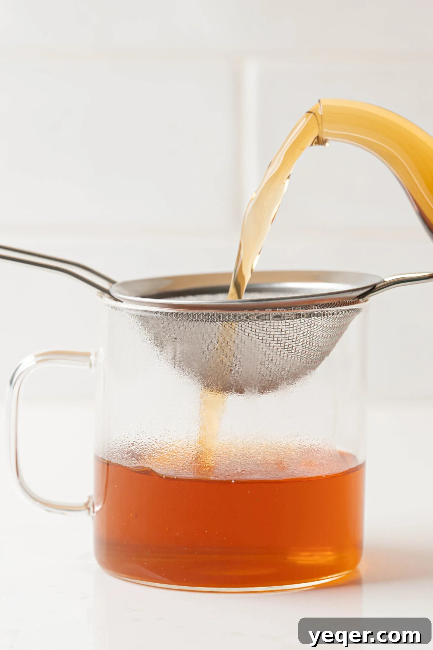 Aromatic Cinnamon Homebrew 7 Cinnamon tea straining into a mug.