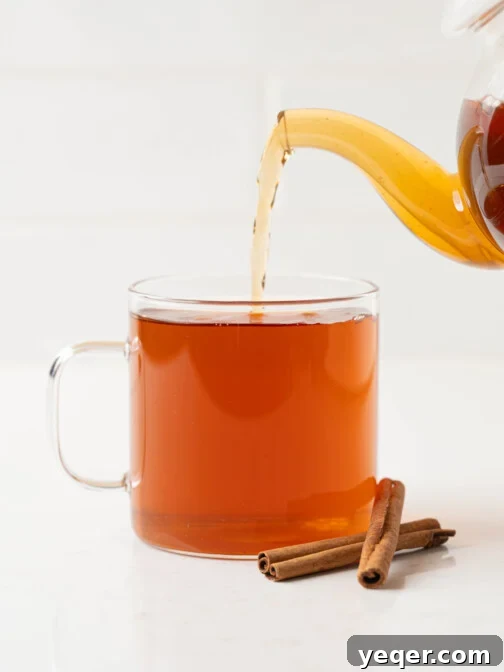 cinnamon tea pouring into a mug