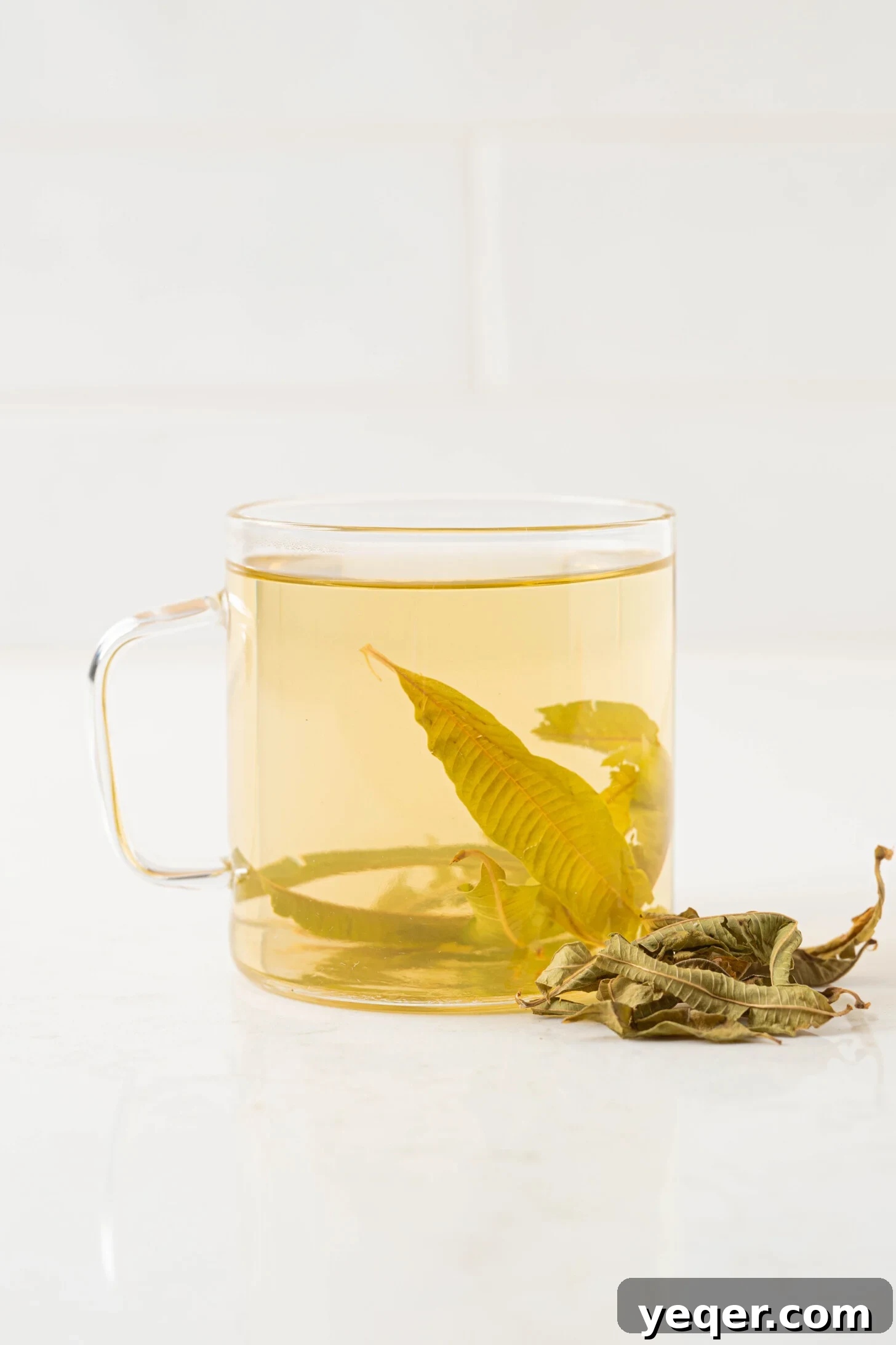 Invigorating Lemon Verbena Tea in 15 Minutes 2 A beautifully presented cup of lemon verbena tea, garnished with fresh leaves, suggesting warmth and tranquility.