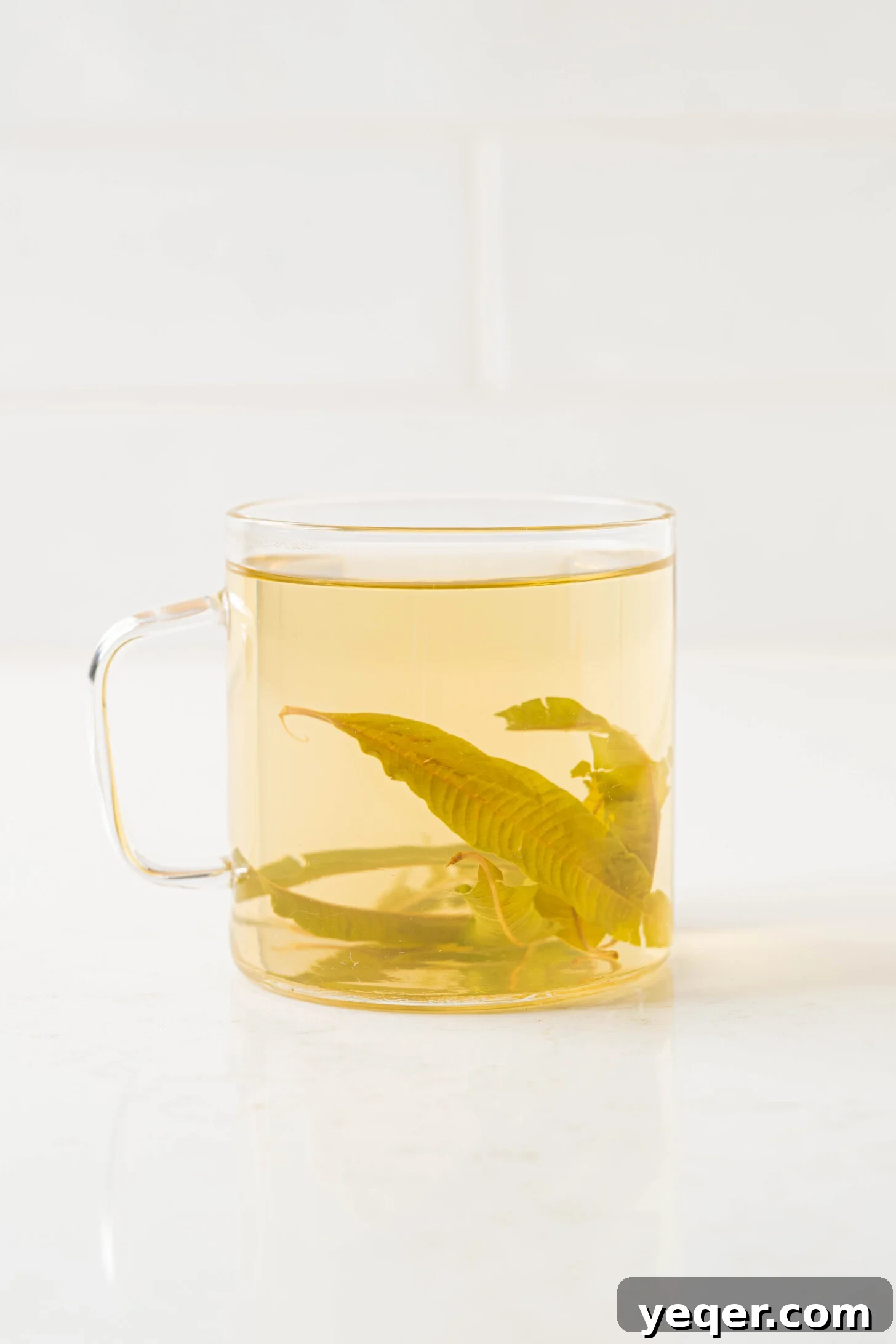 Invigorating Lemon Verbena Tea in 15 Minutes 7 A serene close-up of a cup of lemon verbena tea, garnished with fresh leaves, evoking tranquility and natural beauty.