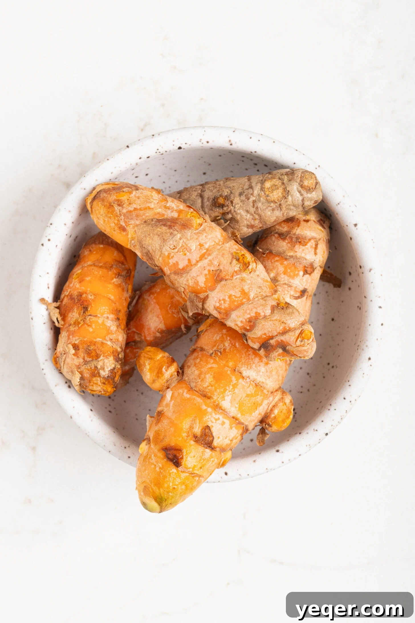 15-Minute Zesty Turmeric Brew 3 a bowl of turmeric root
