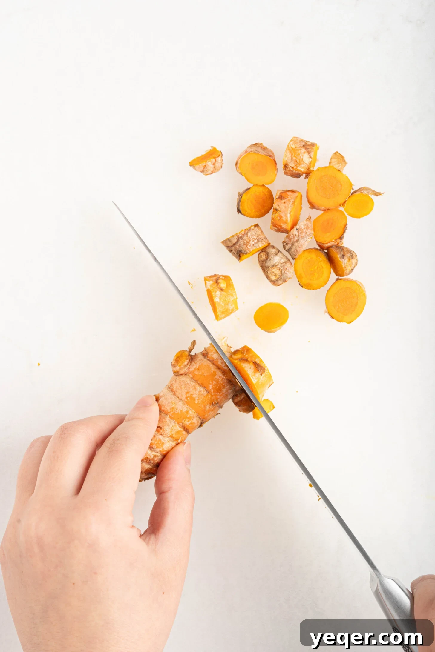 15-Minute Zesty Turmeric Brew 5 turmeric being chopped on a cutting board