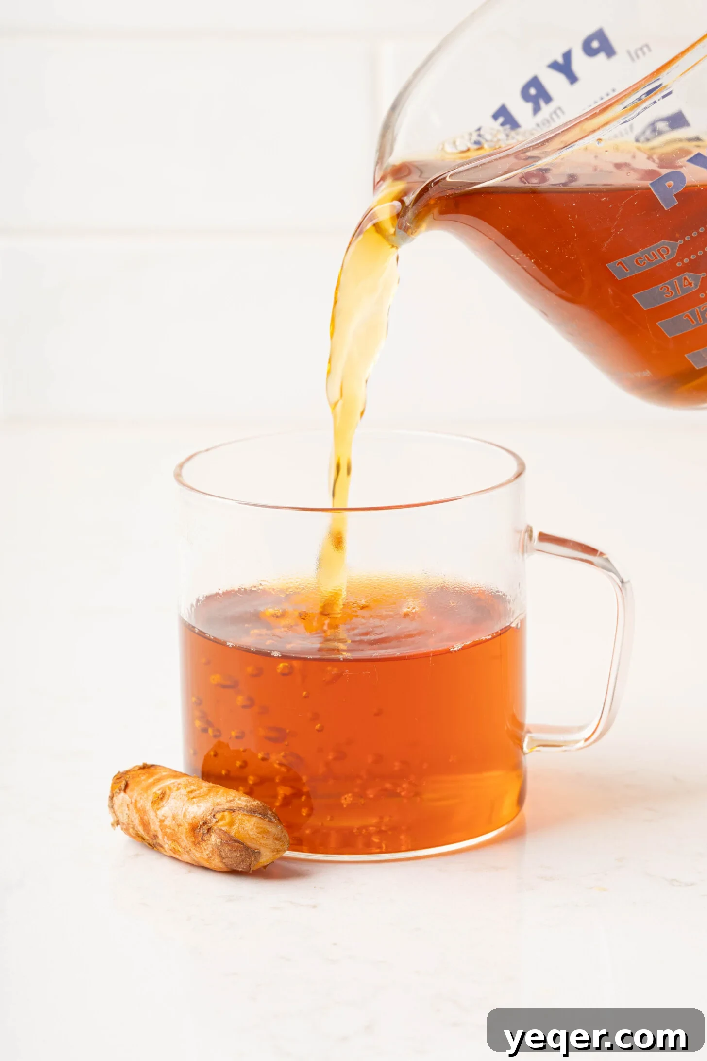 15-Minute Zesty Turmeric Brew 9 turmeric tea pouring into a mug