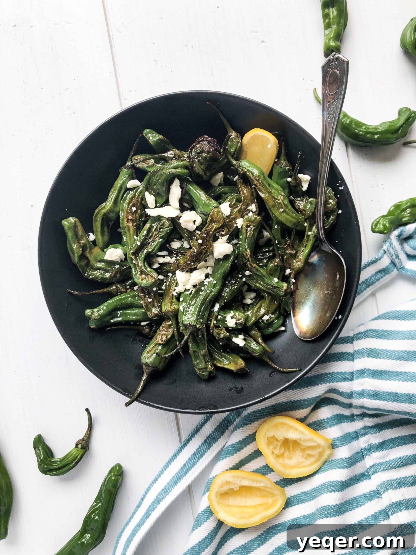 Charred Shishito Peppers with Lemon and Feta 4 A simple yet elegant bowl of blistered shishito peppers, ready to be enjoyed as a healthy and flavorful snack.