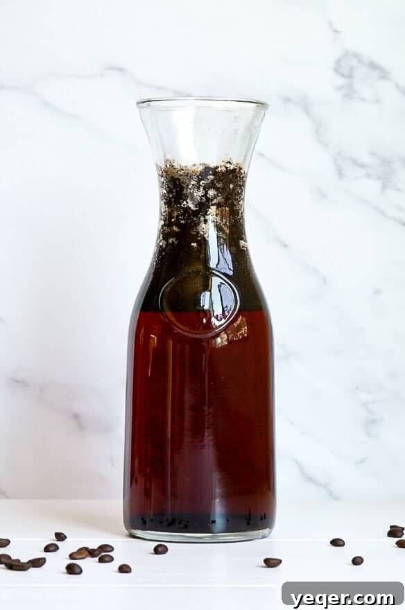 Smooth Cold Brew Overnight Delight 3 A glass jar filled with coarse coffee grounds steeping in water, waiting to be strained.