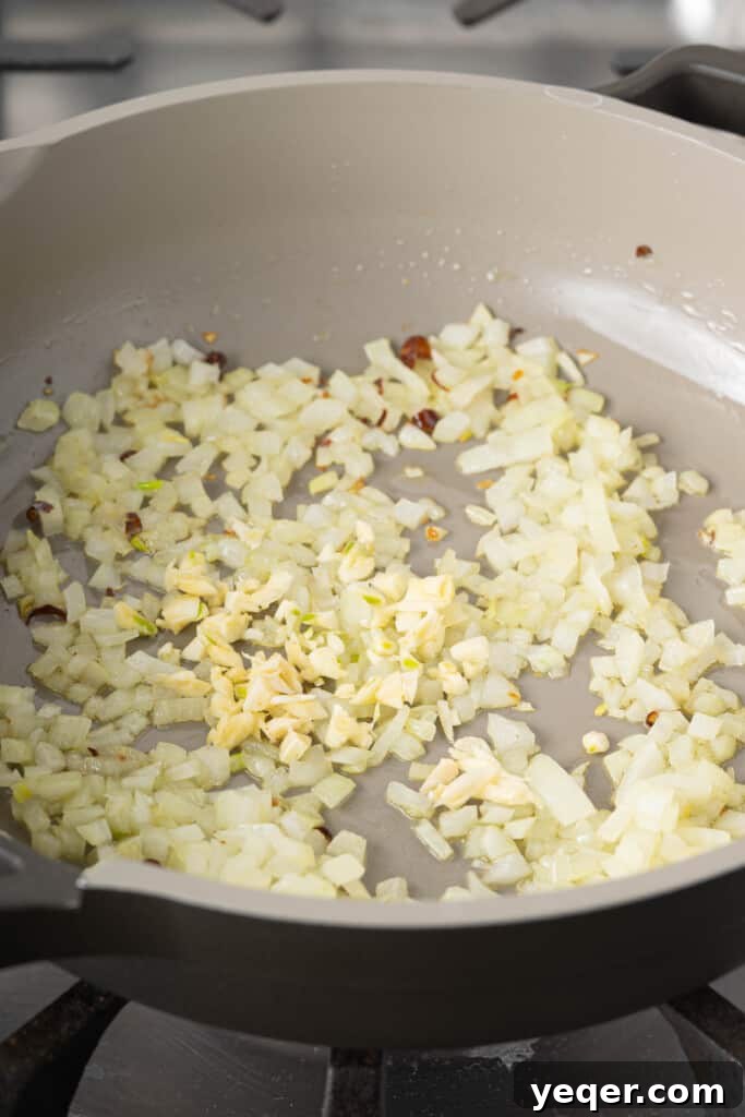 Golden Fluffy Turmeric Basmati Rice 5 garlic, onions, and peppers in a pan