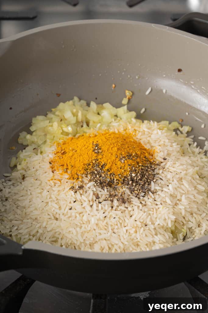 Golden Fluffy Turmeric Basmati Rice 6 rice and spices in a pan